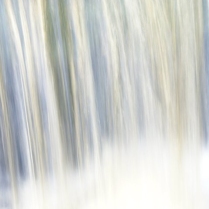 In this abstract image it feels like water cascading fast perhaps a waterfall, wet and white at the bottom where the air become so moist that colours appear.